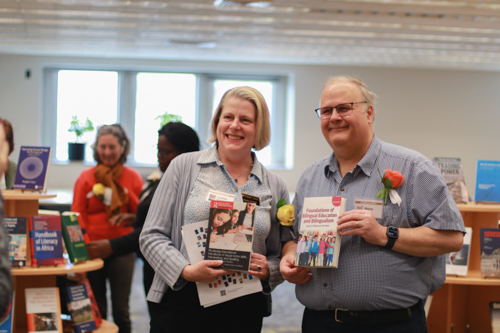 Authors pose with their books 
