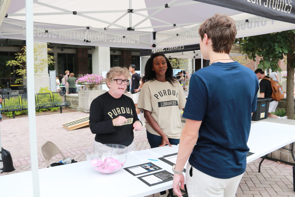 Two Libraries faculty members speaking to a student at the Libraries BGR booth