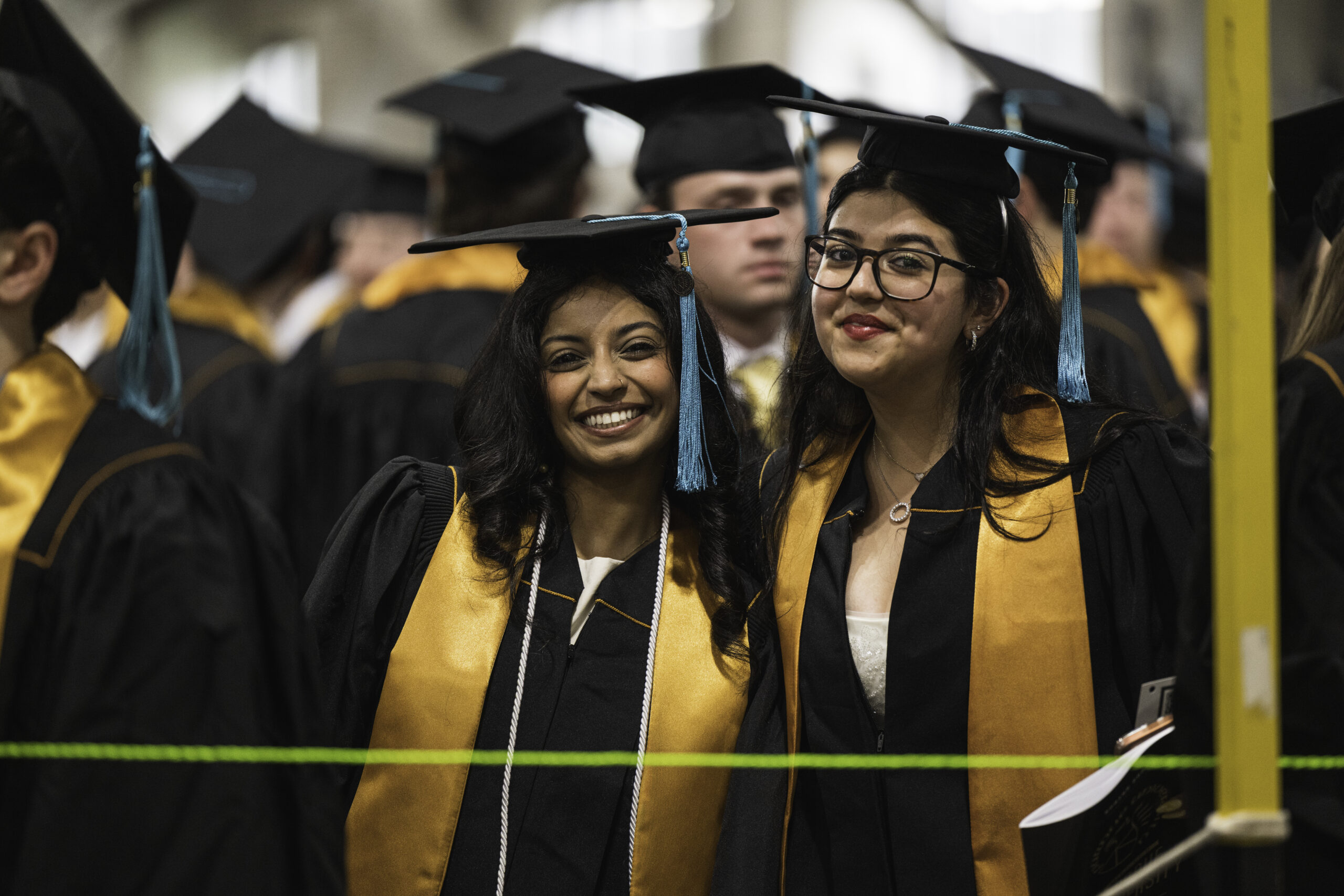 Two female graduates smiling.