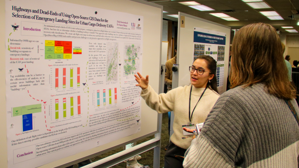 A female student presenting her research poster